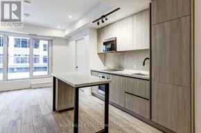 Toronto (Waterfront Communities) condo for rent - A kitchen with a table and chairs in front of a window.
