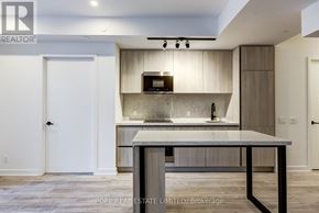 Toronto (Waterfront Communities) condo for rent - A modern kitchen with a large island in the middle.