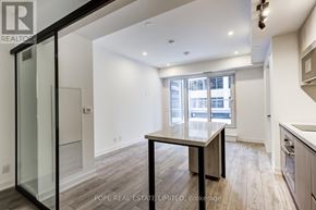 Toronto (Waterfront Communities) condo for rent - A modern kitchen with a dining table and chairs.