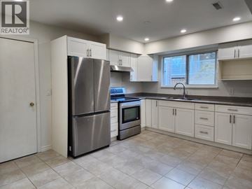 Pitt Meadows apartment for rent - A kitchen with a refrigerator, oven, and microwave.