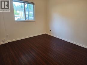 Pitt Meadows apartment for rent - A room with a window and wooden flooring.
