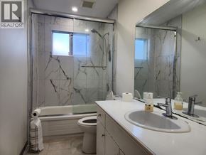 Pitt Meadows apartment for rent - A bathroom with marble tiles and a white sink.