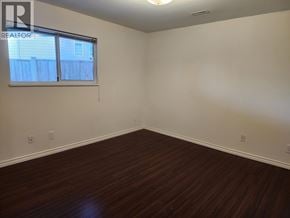 Pitt Meadows apartment for rent - A room with a window and wooden flooring.