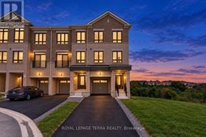 Whitby townhouse for rent - A building with the text "ROYAL LEPAGE TERRA REALTY, Brokerage" in front of it.