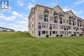 Whitby townhouse for rent - A large building with a lawn in front of it.