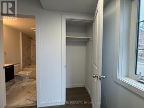 Welland (Broadway) townhouse for rent - A bathroom with a toilet and a sink is shown.