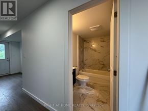 Welland (Broadway) townhouse for rent - A bathroom with a toilet and a bathtub in a room that is under renovation.