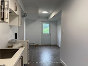 Welland (Broadway) townhouse for rent - A room with a door leading outside and a counter on the left.