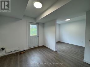Welland (Broadway) townhouse for rent - A room with a door and a window with a view of a garden outside.