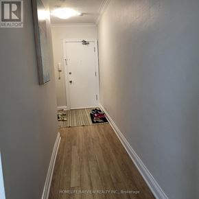 Toronto (Leaside) apartment for rent - A hallway with a white door and a rug on the floor.