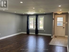 Barrie (Grove East) apartment for rent - A room with wooden flooring and a sliding glass door.
