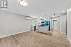 London South (South J) multi-family for rent - A spacious room with a kitchenette and a window.