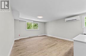 London South (South J) multi-family for rent - A room with a window and a wooden floor.