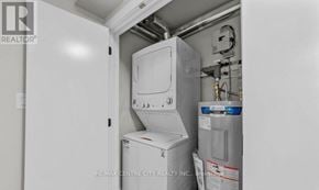 London South (South J) multi-family for rent - A white refrigerator with a water heater and tank on top of it.