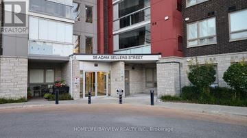 Markham (Cornell) condo for rent - A living room with a grey couch and a white rug.