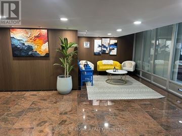 Toronto (L'amoreaux) condo for rent - A living room with a brown wall and a painting on it.