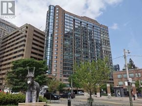 Toronto (Bay Street Corridor) condo for rent - A city street with a large building in the background and a donkey statue in the foreground.