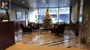 Toronto (Bay Street Corridor) condo for rent - A Christmas tree is in the middle of a room with chairs around it.