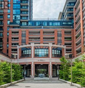 Toronto (Yorkdale-Glen Park) condo for rent - A building with a glass facade and a red brick facade with a sign that says Century 21 Fine Living Realty Inc. brokerage.
