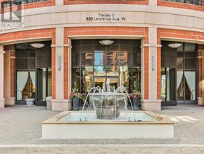Toronto (Yorkdale-Glen Park) condo for rent - A realtor office with a fountain in front.