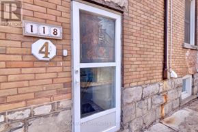 Hamilton (Stipley) apartment for rent - A white door with a glass window is on a brick wall with a sign that says "REALTOR".