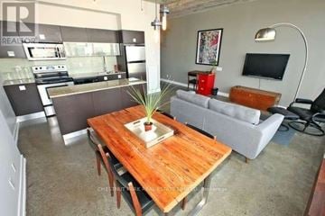 Toronto (Waterfront Communities) condo for rent - A living room with a wooden table in the center and a grey couch.