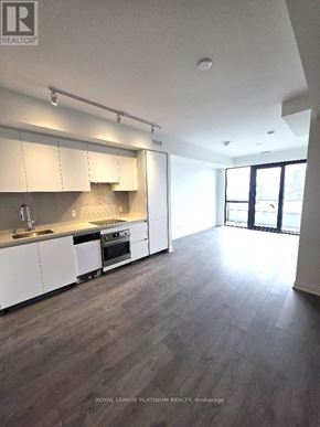 Mississauga (City Centre) condo for rent - A spacious kitchen with white cabinets and a wooden floor.