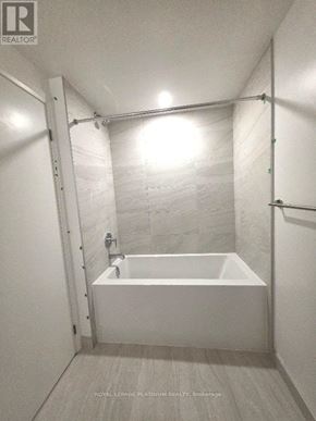 Mississauga (City Centre) condo for rent - A white bathroom with a tub and a shower.