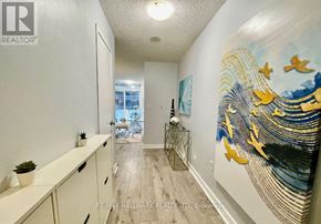 Toronto (Waterfront Communities) condo for rent - A hallway with a mural of birds flying over a body of water.