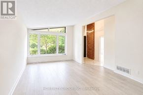 Toronto (Parkwoods-Donalda) apartment for rent - A room with white walls and wooden flooring, with a window and a door visible.