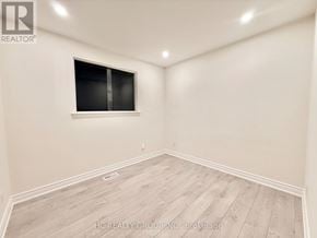 Toronto (Parkwoods-Donalda) apartment for rent - A room with a window and wooden flooring.