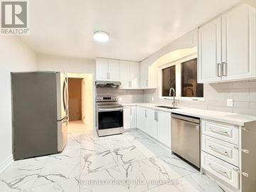 Toronto (Parkwoods-Donalda) apartment for rent - A kitchen with white cabinets and marble tiles.