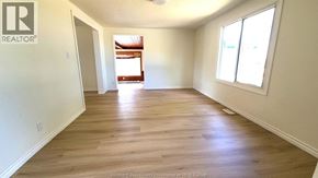 Windsor apartment for rent - A spacious room with wooden flooring and white walls.