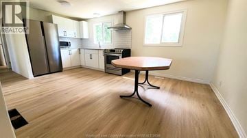 Windsor apartment for rent - A kitchen with a table and a refrigerator.