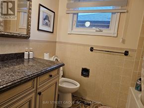 Toronto (Steeles) apartment for rent - A bathroom with a toilet, a counter, and a window.