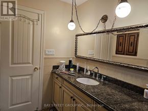 Toronto (Steeles) apartment for rent - A bathroom with a sink, mirror, and light fixture.
