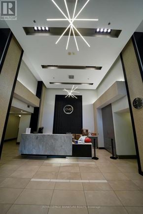 Mississauga (Fairview) condo for rent - A reception area with a large desk and a clock on the wall.