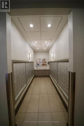 Mississauga (Fairview) condo for rent - A hallway with a sign for Royal LePage Signature Realty on the wall.