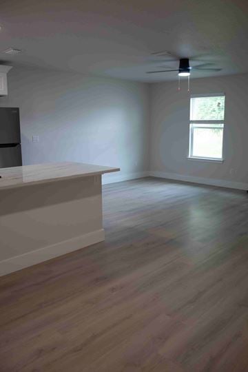 Pensacola apartment for rent - A kitchen with a refrigerator and a window.
