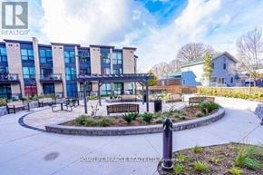 Toronto (West Hill) condo for rent - A real estate company's photo of a residential area with apartment buildings and a house.