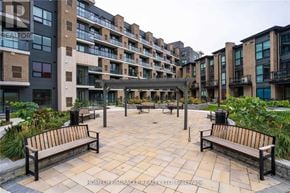 Toronto (West Hill) condo for rent - A courtyard with benches and a building in the background.