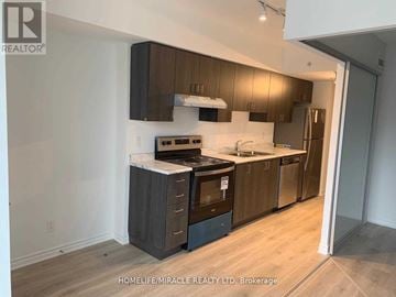 Toronto (West Hill) condo for rent - A kitchen with wooden cabinets and a refrigerator.
