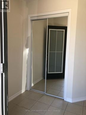 Brantford townhouse for rent - A white door with a glass panel is open in a room.