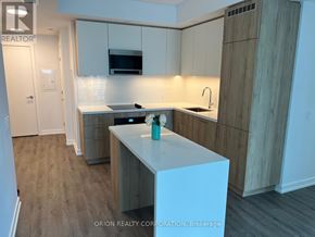 Vaughan (Vaughan Corporate Centre) condo for rent - A kitchen with a white counter top and wooden cabinets.