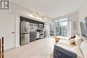 Toronto (Little Portugal) condo for rent - A modern kitchen with stainless steel appliances and a large window.