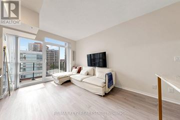 Toronto (Little Portugal) condo for rent - A living room with a white couch and a flat screen TV.