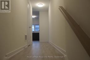 Guelph (Clairfields/Hanlon Business Park) townhouse for rent - A hallway with a Royal LePage logo on the wall.
