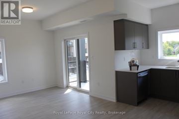 Guelph (Clairfields/Hanlon Business Park) townhouse for rent - A kitchen area with a sink, cabinets, and a window.