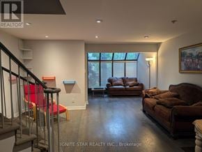 Toronto (Church-Yonge Corridor) townhouse for rent - A living room with a brown couch and a red chair.