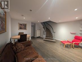 Toronto (Church-Yonge Corridor) townhouse for rent - A living room with a brown couch and a red chair.